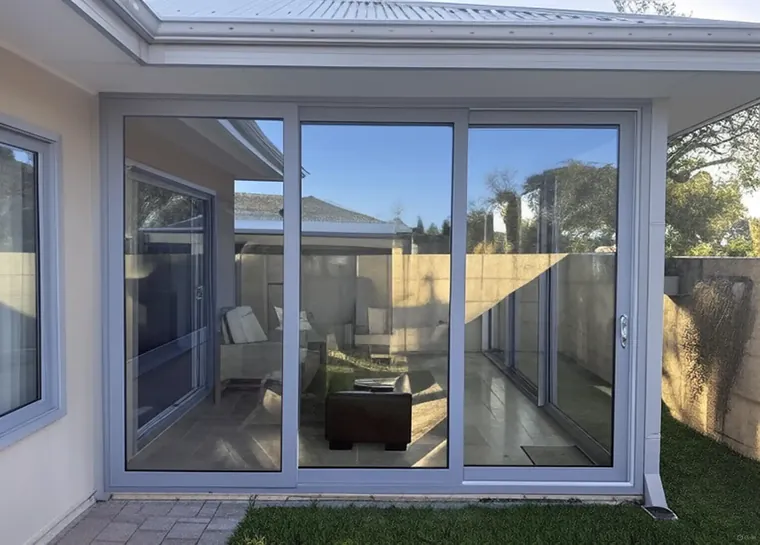 Premier uPVC stacking doors opening to a paved courtyard